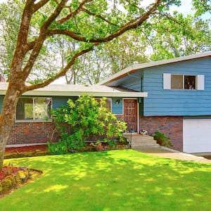 Blue rambler house with two car garage