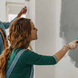 Young couple painting walls