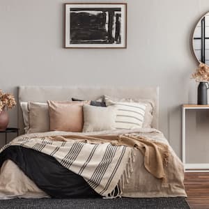 Neutral toned bedroom with bed and desk