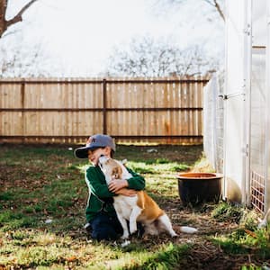 A young boy hugging a dog