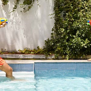 Father and son playing at the swimming pool