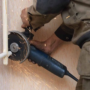 Plumber cutting the metal pipe