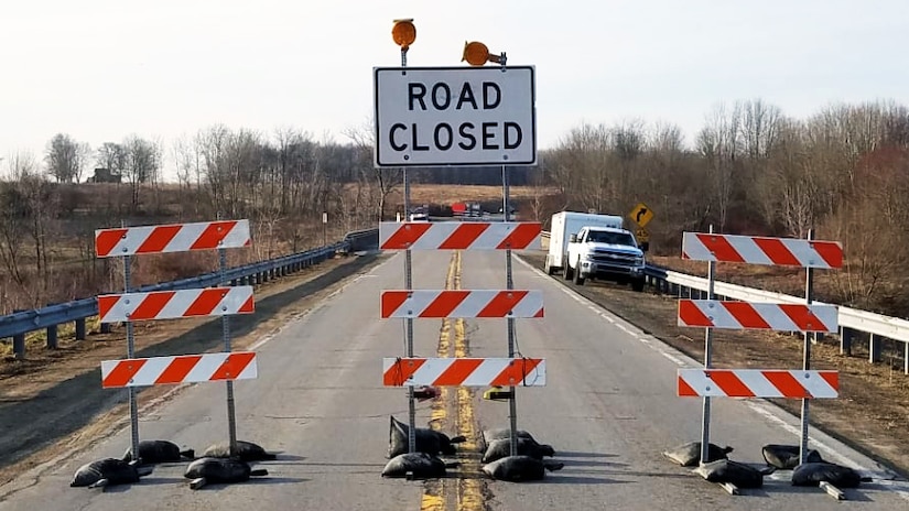 Road closed signs on a road.