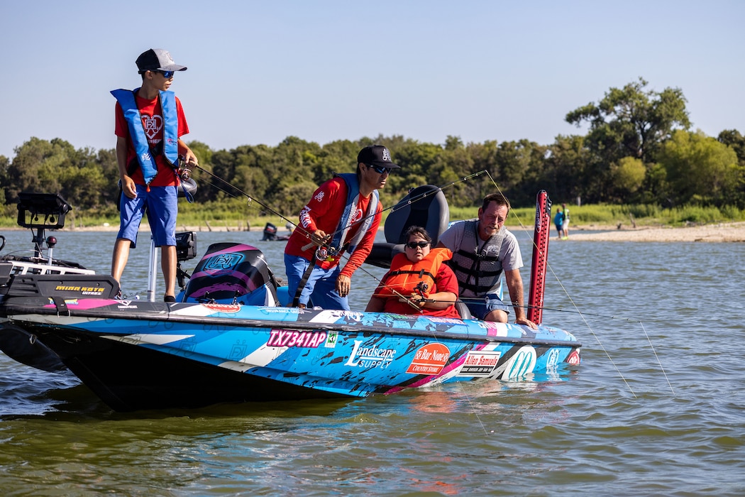 people fish from a boat on a lake