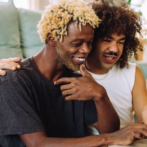 A couple using a laptop in their living room