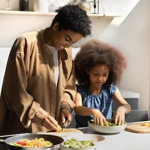 Mother and daughter cooking together 