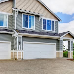 grey and beige house with concrete driveway