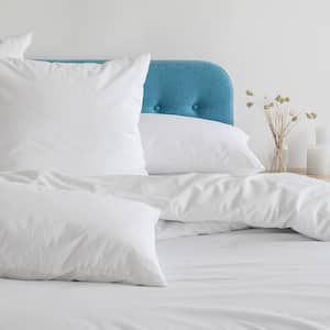 Bed with white duvet and white pillows