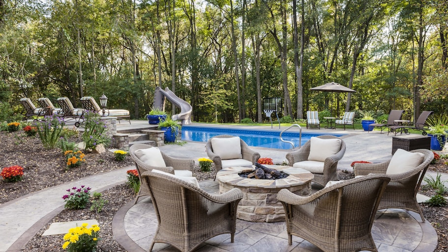 Wicker patio chairs centered around fire pit