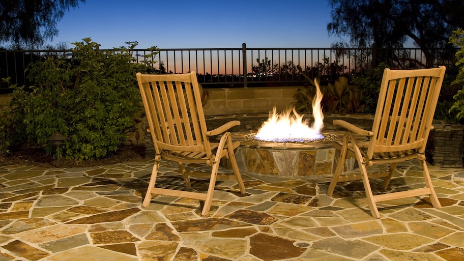 Fold-up wooden chairs over flagstone patio