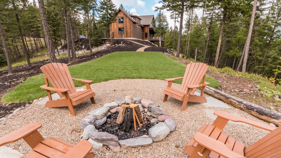 Wooden Adirondack chairs surrounding fire pit