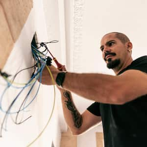 Electrician prepares the installation of electrical wiring