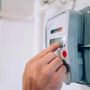 A person reading an electrical meter