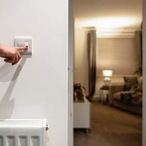 woman turning off lights with switch