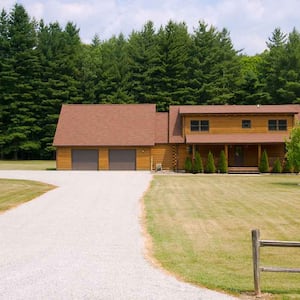 A view of a house with a gravel driveway