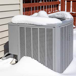 HVAC unit in a snow covered backyard
