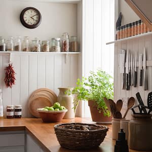 A view of a sunny kitchen with potted herbs