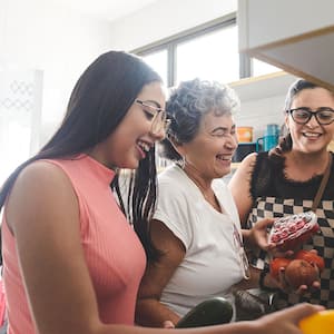 A happy family cooks a meal together