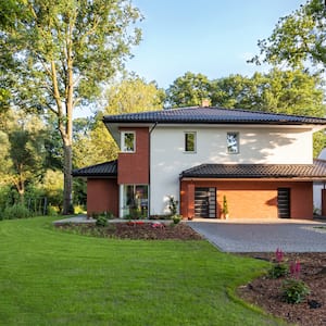 beautiful house surrounded by healthy  trees