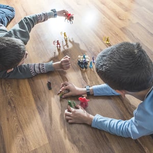 Boys playing with toys on vinyl flooring