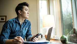 Man working from home looking out his window