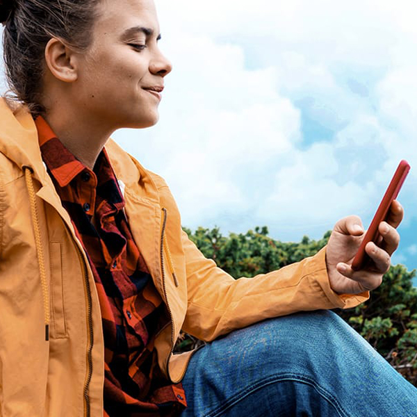 Person sitting down with mountains in the background