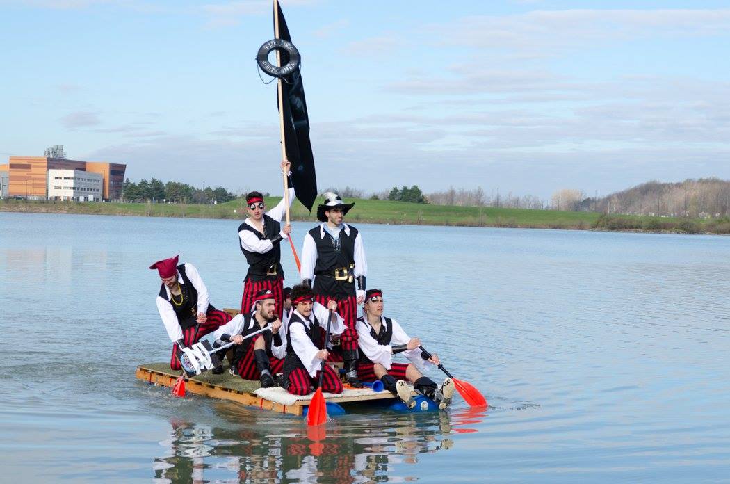 An Oozefest team dressed as pirates, sailing a raft across Lake LaSalle.