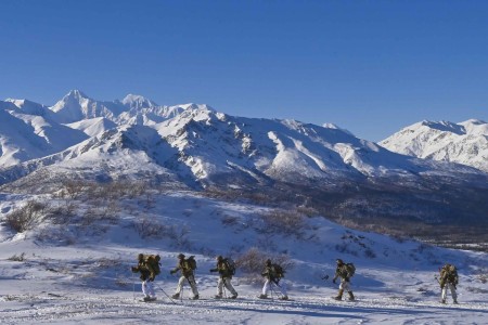 Cold Weather Leader Course 23-005 students snowshoe into position for avalanche safety training at the Black Rapids Training Site in Alaska Feb. 27, 2023. The course is one of many offered by the Northern Warfare Training Center.