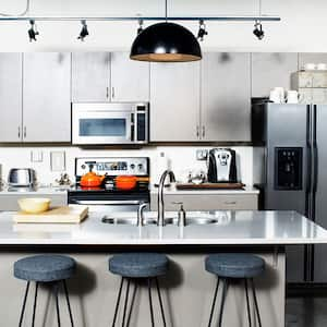 A view of a kitchen with a microwave over the stove