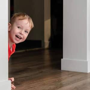Little boy playing hide and seek at home