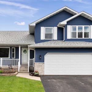 A suburban house with blue siding