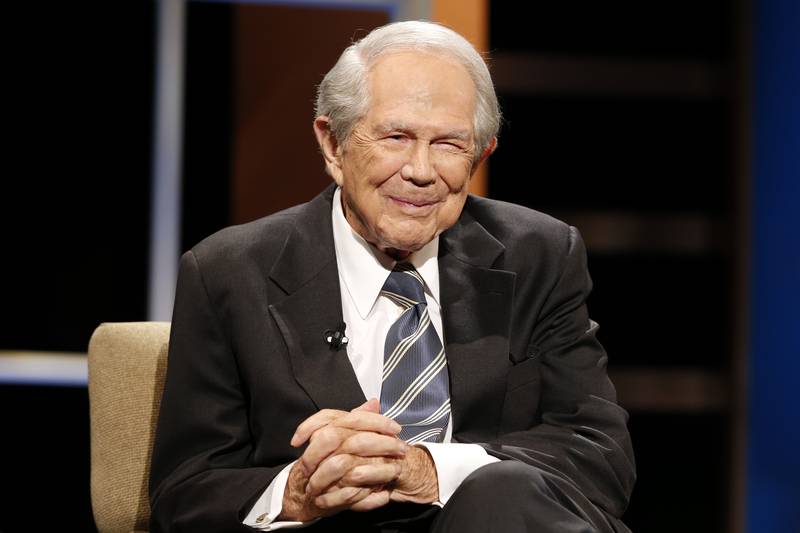 FILE - Rev. Pat Robertson poses a question to a Republican presidential candidate during a...