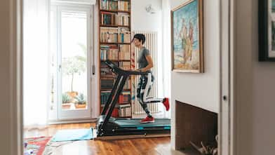 woman running on treadmill in living room setting