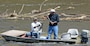 Two fisherman land an American shad fish at Lock and Dam 1.   