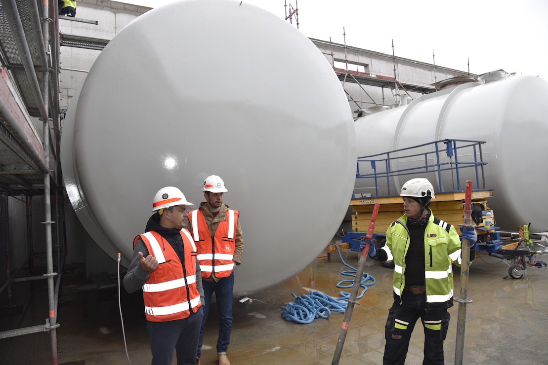 U.S. Army Corps of Engineers, Europe District Quality Assurance Engineer Jüri Saljukov, a local Estonian national employee, discusses progress with a local contractor at the ongoing construction of a bulk fuel storage facility at Amari Air Base in Estonia May 12, 2022. Over the past several years, the U.S. Army Corps of Engineers has delivered various projects in Estonia and neighboring Baltic countries Latvia and Lithuania through the European Deterrence Initiative where military infrastructure is built to enhance the U.S. deterrence posture, increase the readiness and responsiveness of U.S. forces in Europe, support the collective defense and security of NATO allies, and bolster the security and capacity of U.S. allies and partners. (U.S. Army photo by Chris Gardner)