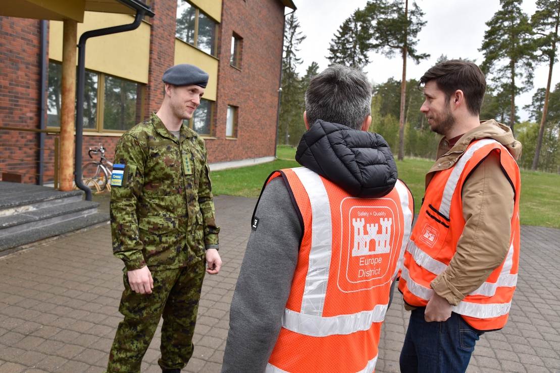 Estonian Air Force Capt. Kaur Käämer discusses U.S. and Estonian partnership and European Deterrence Initiative construction with U.S. Army Corps of Engineers, Europe District Quality Assurance Engineer Jüri Saljukov and Project Engineer Chris Bailey at Amari Air Base in Estonia May 12, 2022. Over the past several years, the U.S. Army Corps of Engineers has delivered various projects in Estonia and neighboring Baltic countries Latvia and Lithuania through the European Initiative (EDI). Under the EDI program military infrastructure is built to enhance the U.S. deterrence posture, increase the readiness and responsiveness of U.S. forces in Europe, support the collective defense and security of NATO allies, and bolster the security and capacity of U.S. allies and partners. (U.S. Army photo by Chris Gardner)