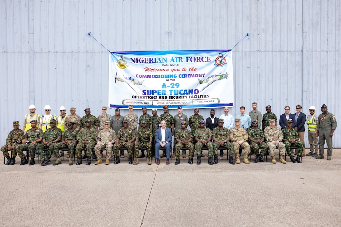 A large group of people gather together for a formal photo