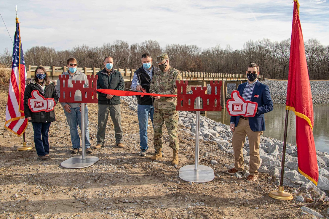 IN THE PHOTO, Memphis District Commander Col. Zachary Miller and other district leadership were briefed on the details of the St. Francis bridge (CR736) project at the exact site where the construction took place. Afterward, the group held a ribbon-cutting ceremony (in the photo), symbolizing the victory and celebration of completing yet another significant project. (USACE photo by Vance Harris)