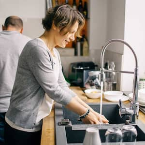 Couple at home cleaning the kitchen together