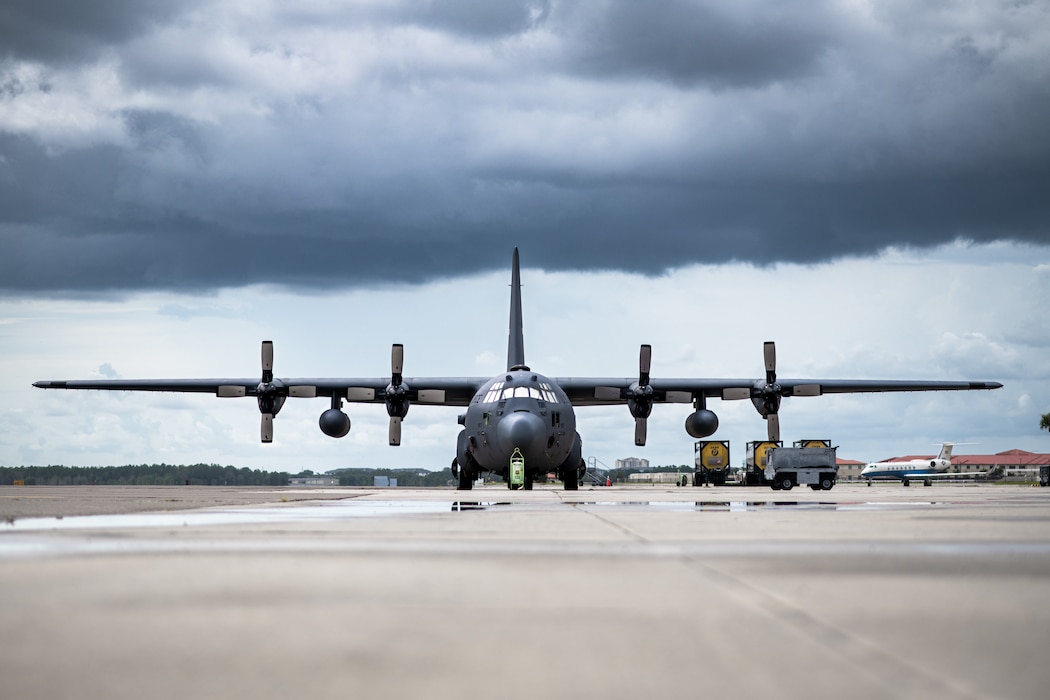 A C-130 Hercules sits on the flightline