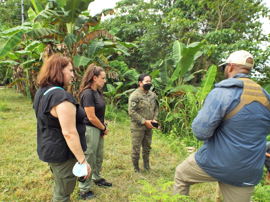 three members of a Forward Engineering Support Team talk with a Soldier from the Philippines Army at a site in Camp Dela Cruz, Philippines.