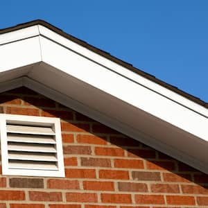 A gable vent on a brick house