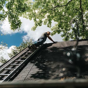 A man climbs a roof