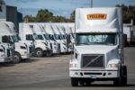 A FLEET OF TRUCKS BEARING THE YELLOW LOGO