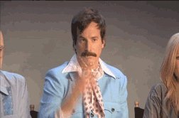 a man with a mustache throwing glitter in a dramatic way