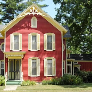 Red Victorian home in peaceful setting