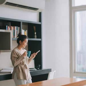 Woman checking her phone in the living room