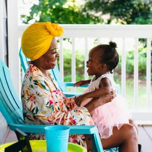 Mother and daughter sitting on front porch