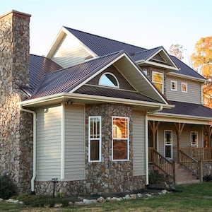 Beige house with new metal roof 