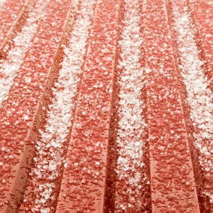 Hail ice rain on a red corrugated tin roof 